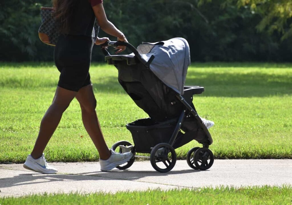Mother walking with a stroller with her baby in it